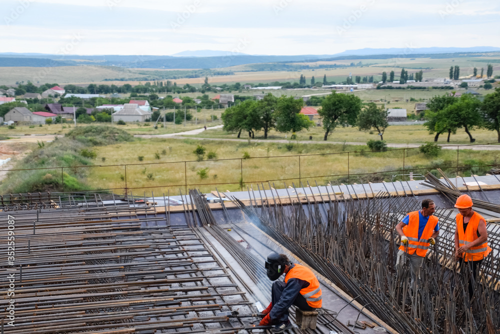 Construction of new road and transport interchange. Work on reinforced concrete structures and road surface.