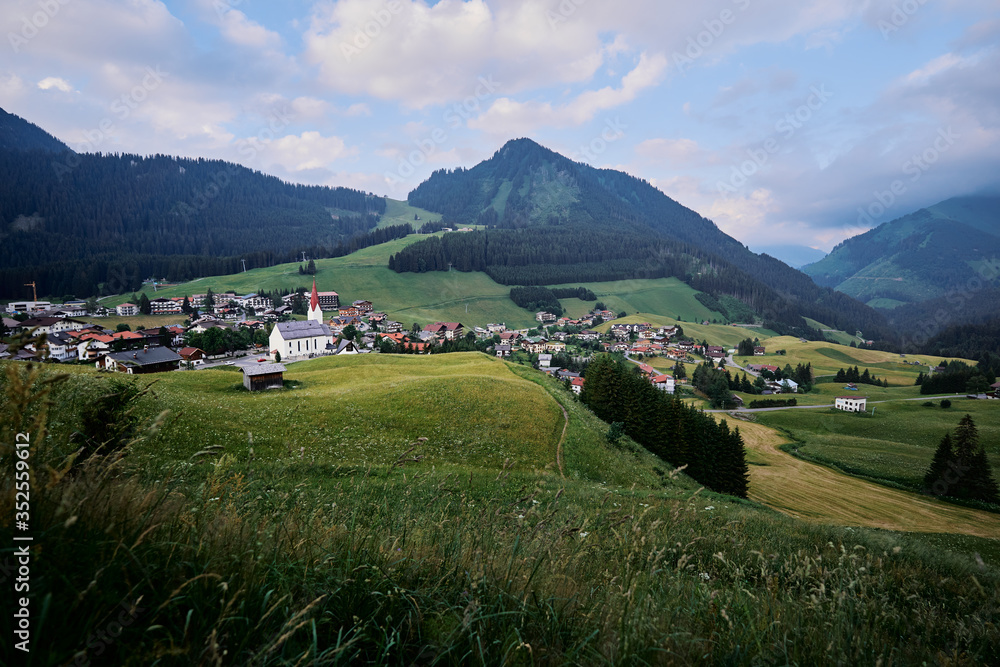 Amazing alpine scenery from Berwang, Austria. Summer landscape with green fields and Alps Mountains.