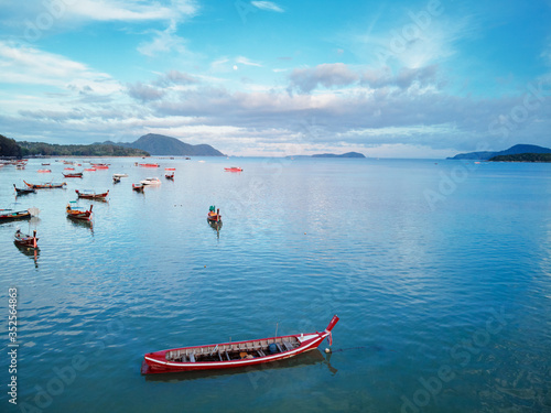 Travel Asia. Beautiful tropical seascape.Traditional thai longtail boats in blue lagoon Rawai beach in Phuket island. photo