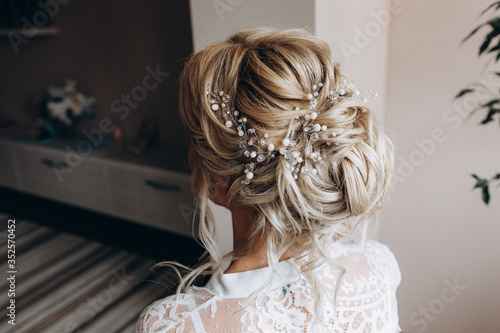 Beautiful hairstyle of the bride. Jewelry in the hair. The morning of the bride. Preparing for the ceremony.