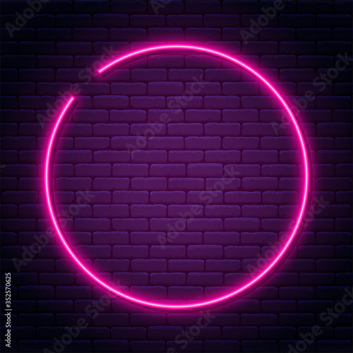 Neon sign in circle shape. Bright neon light, illuminated round frame. Glowing purple neon tube on dark background. Signboard or banner template in 80s and 90s style
