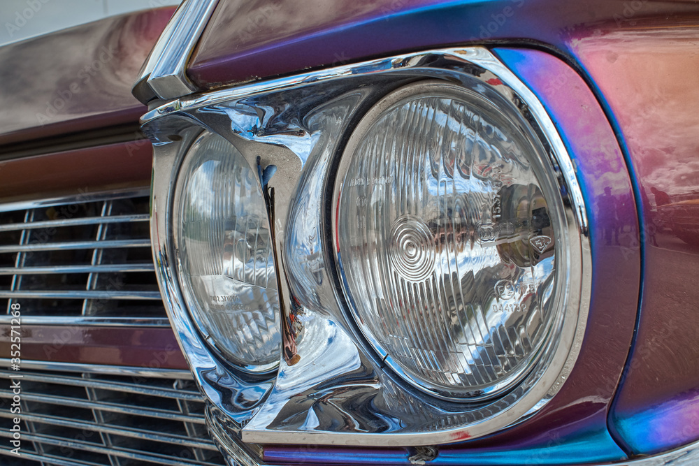 Car headlight close-up retro car auto parts. Head light of the car, a beautiful car design