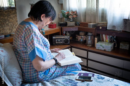 Old Woman reading the book in his room