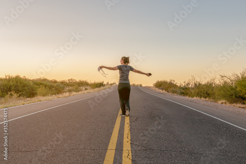 free woman with covers face in hand walking towards freedom