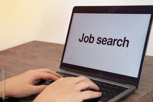 Job search. Using laptop to find a job. Concept of coronavirus pandemic cause economic crisis and unemployment. selective focus