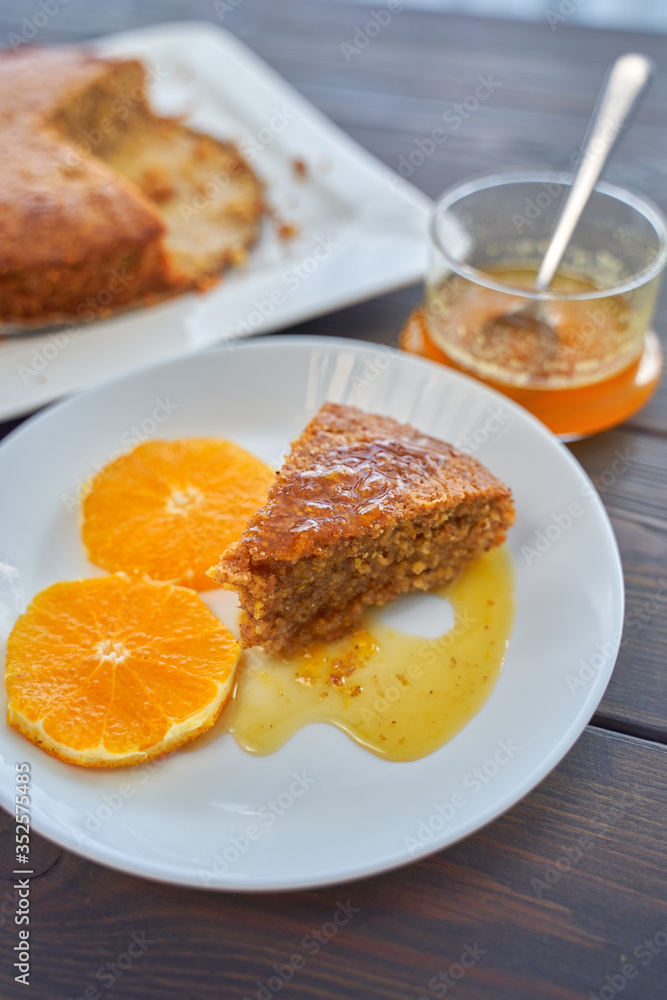 Homemade orange cake on a dark wooden kitchen table. Vegan and Gluten Free. Homemade orange cake on a dark wooden kitchen table. Vegan and Gluten Free.