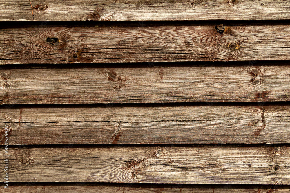 Old brown wooden wall background texture close up