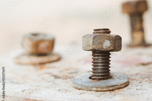 Old steel head bolts or nut with ring and screws rusted close-up with vintage tone.