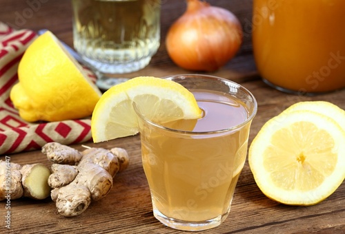 Hot tea against cough and flu made from onion, ginger, lemon and honey. Homemade tea from raw cut onion, lemon, ginger and hot water.