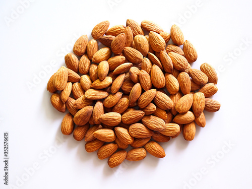 Pile of almonds seeds isolated on white background.