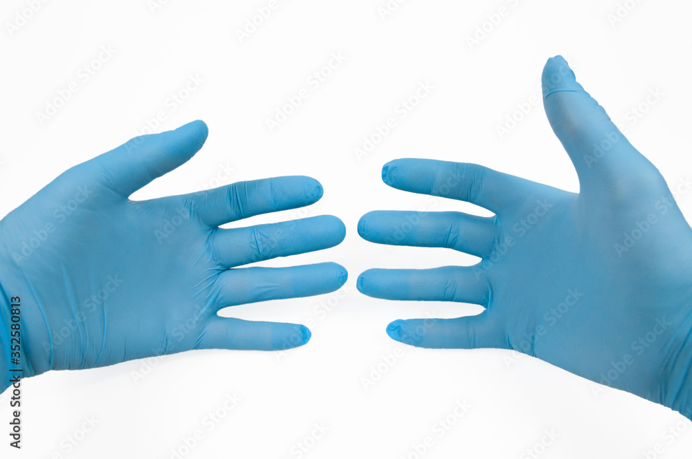 right and left hands of the doctor in blue gloves on a white background
