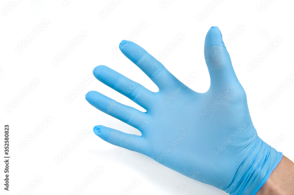 one hand in a blue glove with open fingers and palm up on a white background one hand in a blue glove with open fingers and palm up on a white background
