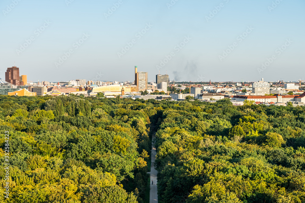 Panoramic city view of Berlin, viewfrom the top of the Berlin Victory Column in Tiergarten, Berlin, with modern skylines and green forest.