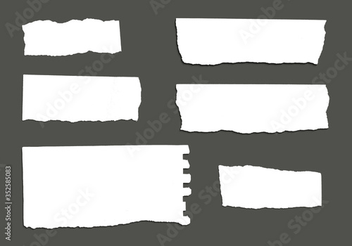 White ripped striped note, copybook, notebook paper stuck on light gray,black background.
