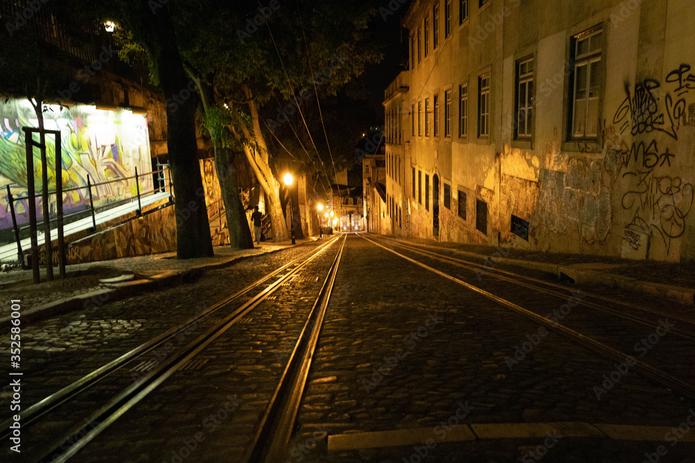 Night view of the Lisbon tram with graffiti.