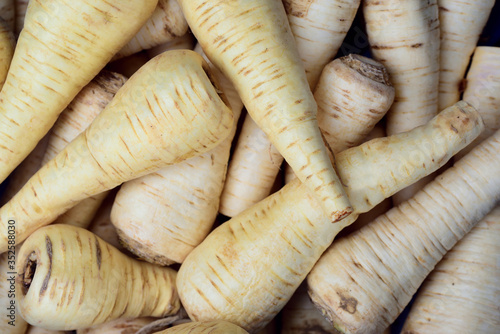 Background and close up of white parsley root, on the market, which is on sale