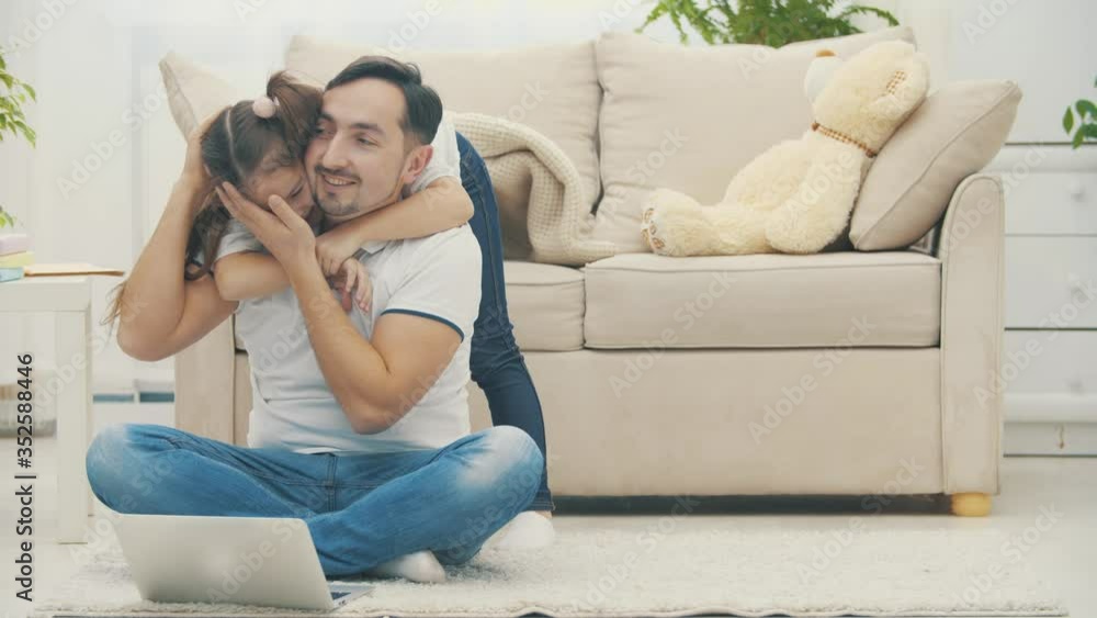 Father is online while his daughter hugging him in 4k slowmotion video. Father is online while his daughter hugging him in 4k slowmotion video.