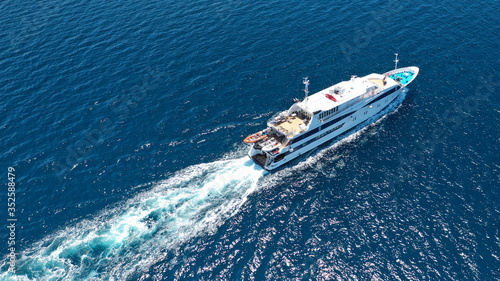 Aerial drone photo of yacht cruising in high speed in open ocean Aegean deep blue sea, Greece