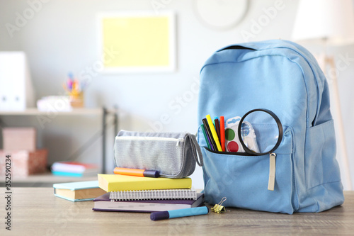 school backpack and stationery in a bright room. Preparing for school. Back to school. Place for text. National School Backpack Awareness Day