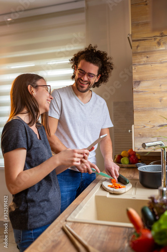 Couple in love preparing food in the kitchen