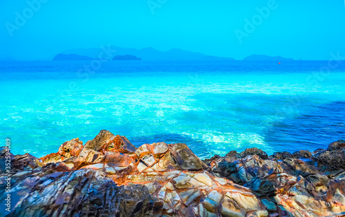 Beach, beautiful panoramic sea view, with clean water, blue sky and some brown rocks