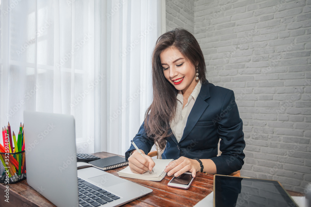 Attractive businesswoman with laptop working in office her. Attractive businesswoman with laptop working in office her.