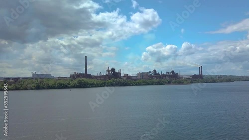 Aerial view of metallurgical plant, Industrial zone with a large pipes thick white smoke is poured from the factory pipe. Pollution of the environment. Kamenskoye. Ukraine. 4K photo