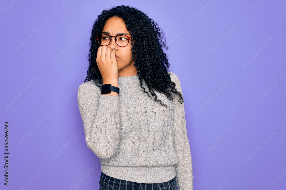 Young african american woman wearing casual sweater and glasses over purple background looking stressed and nervous with hands on mouth biting nails. Anxiety problem. Young african american woman wearing casual sweater and glasses over purple background looking stressed and nervous with hands on mouth biting nails. Anxiety problem.