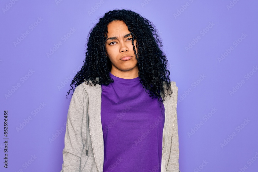 Young african american sporty woman wearing casual sweatshirt over purple background depressed and worry for distress, crying angry and afraid. Sad expression. Young african american sporty woman wearing casual sweatshirt over purple background depressed and worry for distress, crying angry and afraid. Sad expression.