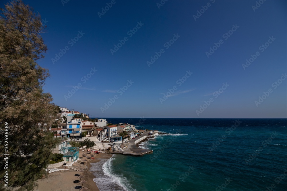 Armenistis, Ikaria, North Aegean Islands, Greece, beautiful picture-perfect traditional Greek fishing village with typical white washed houses and turquoise blue sea