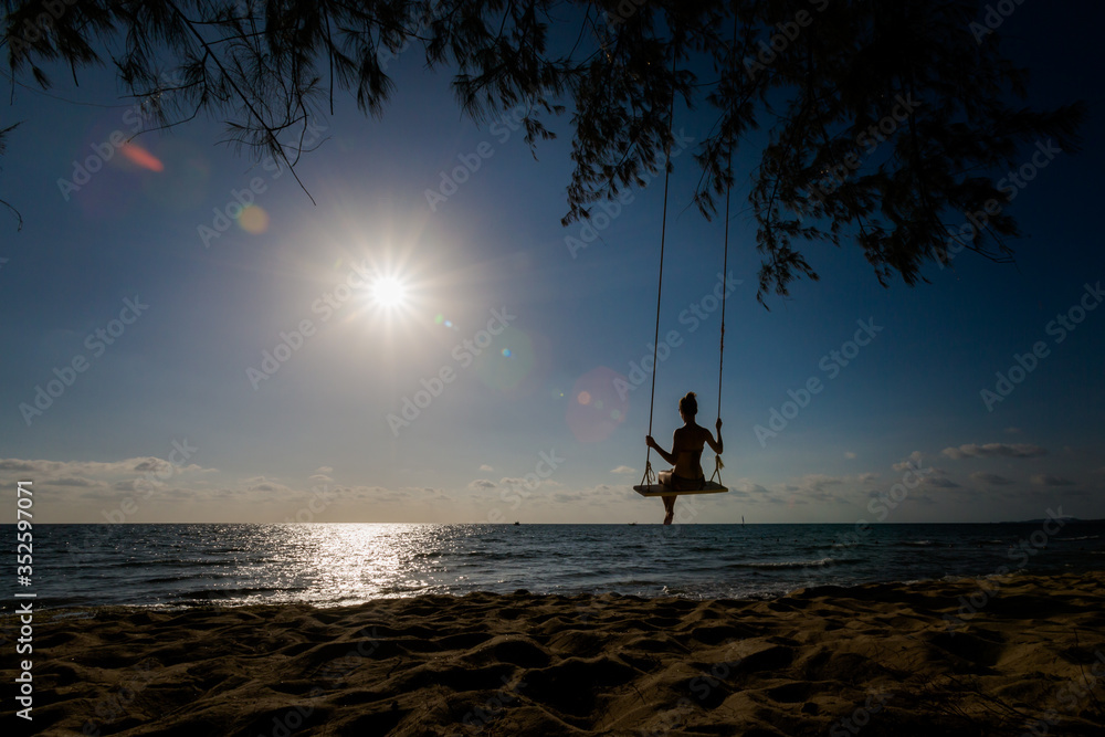 Young woman on swing in tropical Vietnam