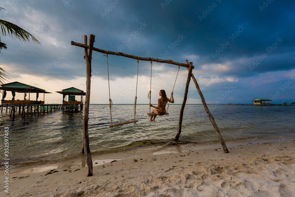 Young woman on swing in tropical Vietnam