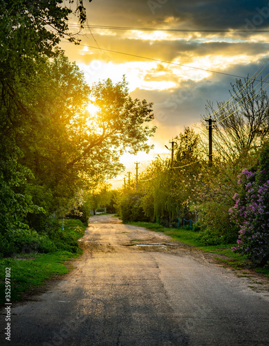 Sunset in the Ukrainian village. Evening on the road