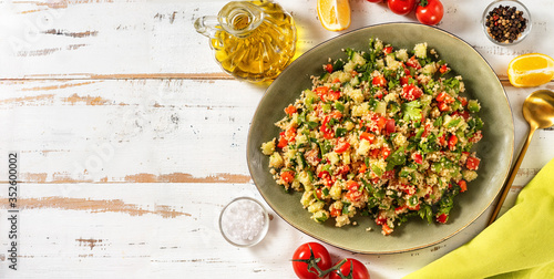 Top view of fresh summer vegan couscous salad with vegetables photo