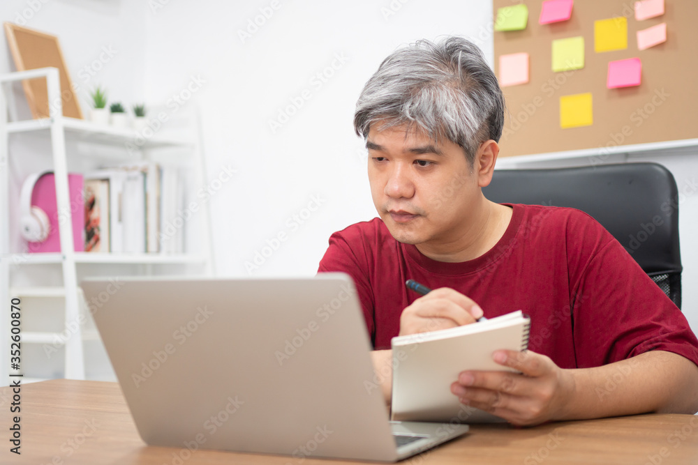 Asian freelance studying for new skills from the internet at home after working is finished. Concept of learning online and new lifestyle, internet technology, and information for a new normal life Asian freelance studying for new skills from the internet at home after working is finished. Concept of learning online and new lifestyle, internet technology, and information for a new normal life