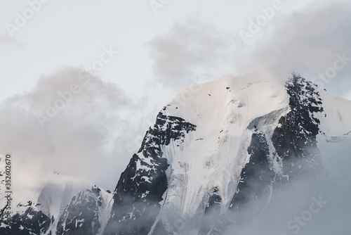 Obraz na plátně Atmospheric minimalist alpine landscape with massive hanging glacier on snowy mountain peak