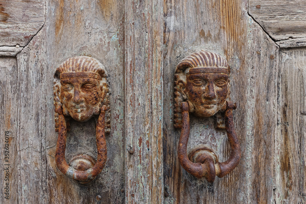 rusty door knocker on a weathered door rusty door knocker on a weathered door