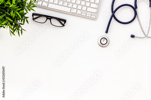 Doctor office desk with keyboard. White table top view space for text
