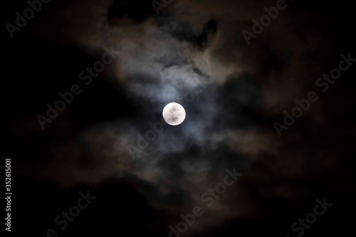 super moon in the night sky and clouds