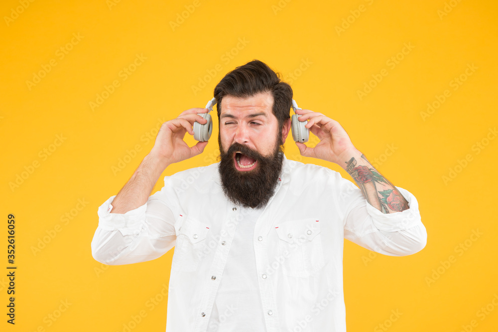 Hearing problem. Bearded man headphones. Active Noise Cancellation Technology. Hipster listen music stereo headphones. Modern wireless headphones. Dance music tracks. Ears health. Loud music - obrazy, fototapety, plakaty 