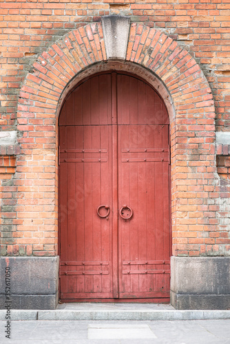 vintage red arched brick door around the door