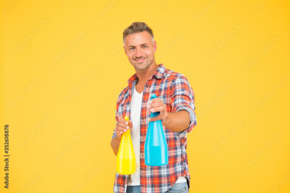 Ready to spray. Happy man hold spray bottles yellow background. Spray cleaning. Trigger sprayer dispensers. Spray wash and washing. House cleaner. Housing household. Dissolving away stubborn stains Ready to spray. Happy man hold spray bottles yellow background. Spray cleaning. Trigger sprayer dispensers. Spray wash and washing. House cleaner. Housing household. Dissolving away stubborn stains