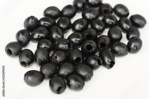 Delicious black olives on a white plate 