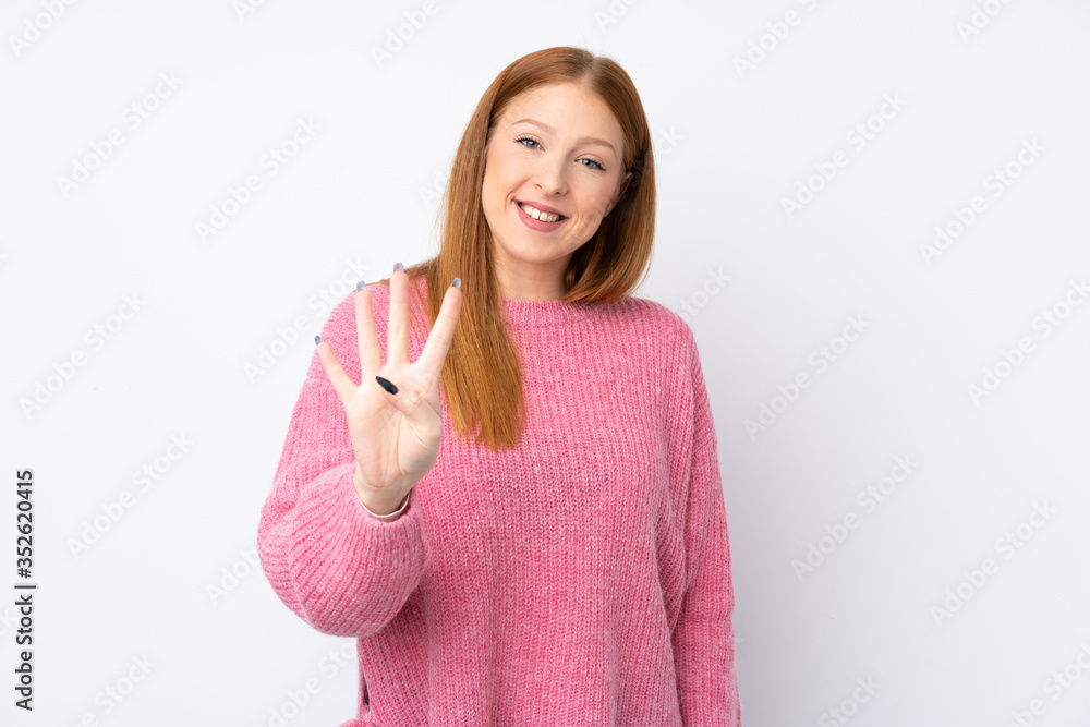 Young redhead woman with pink sweater over isolated white background happy and counting four with fingers Young redhead woman with pink sweater over isolated white background happy and counting four with fingers