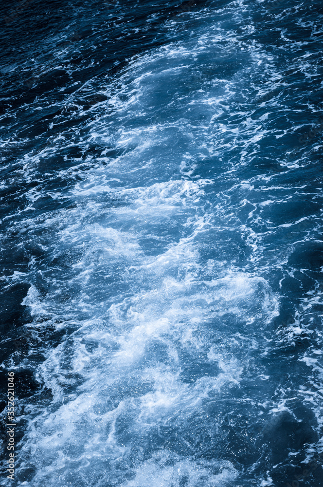 Dark blue ocean with white spray / Nature background, dark blue ocean with white spray.