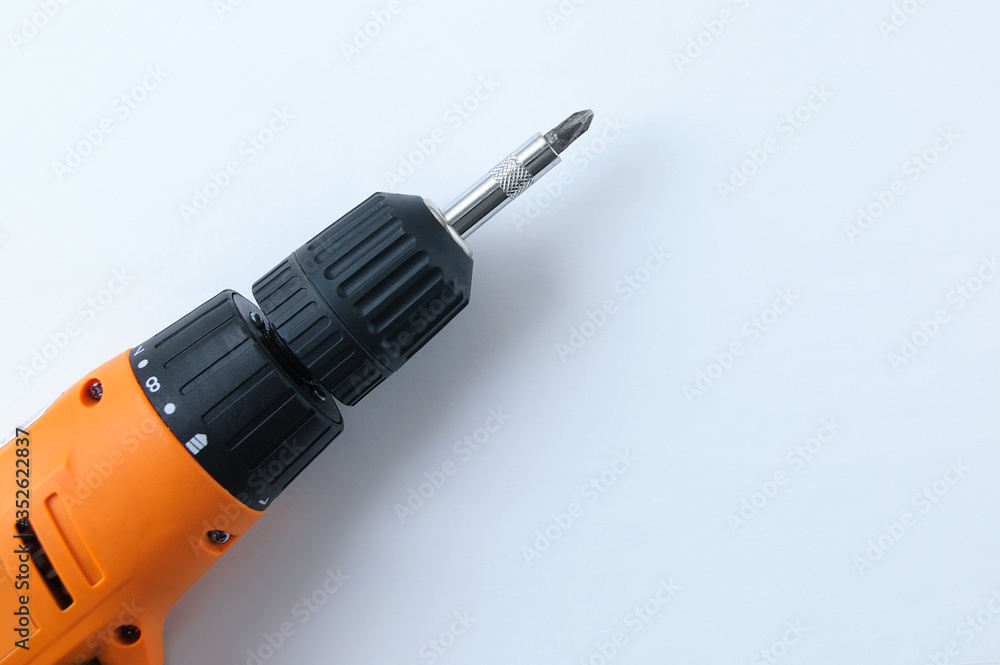 Close-up drill screwdriver on white background. View from above. Close-up drill screwdriver on white background. View from above.