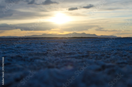 A golden sunset over the cool calm salty  landscape of the great salt lake basin in the utah area under the sun. 
