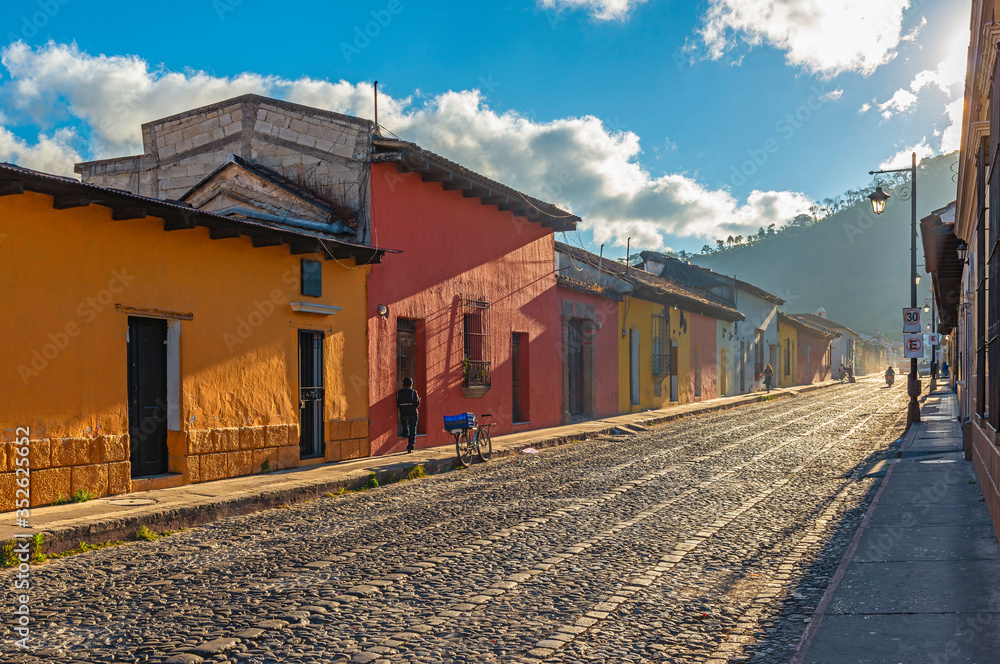 City life at sunrise in the colorful colonial style streets of Antigua, Guatemala.