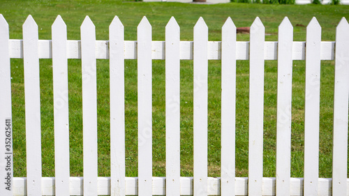 white picket fence on green grass