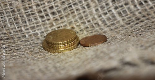 Some Euro coins on burlap canvas background. Little money concept. Powerty concept photo